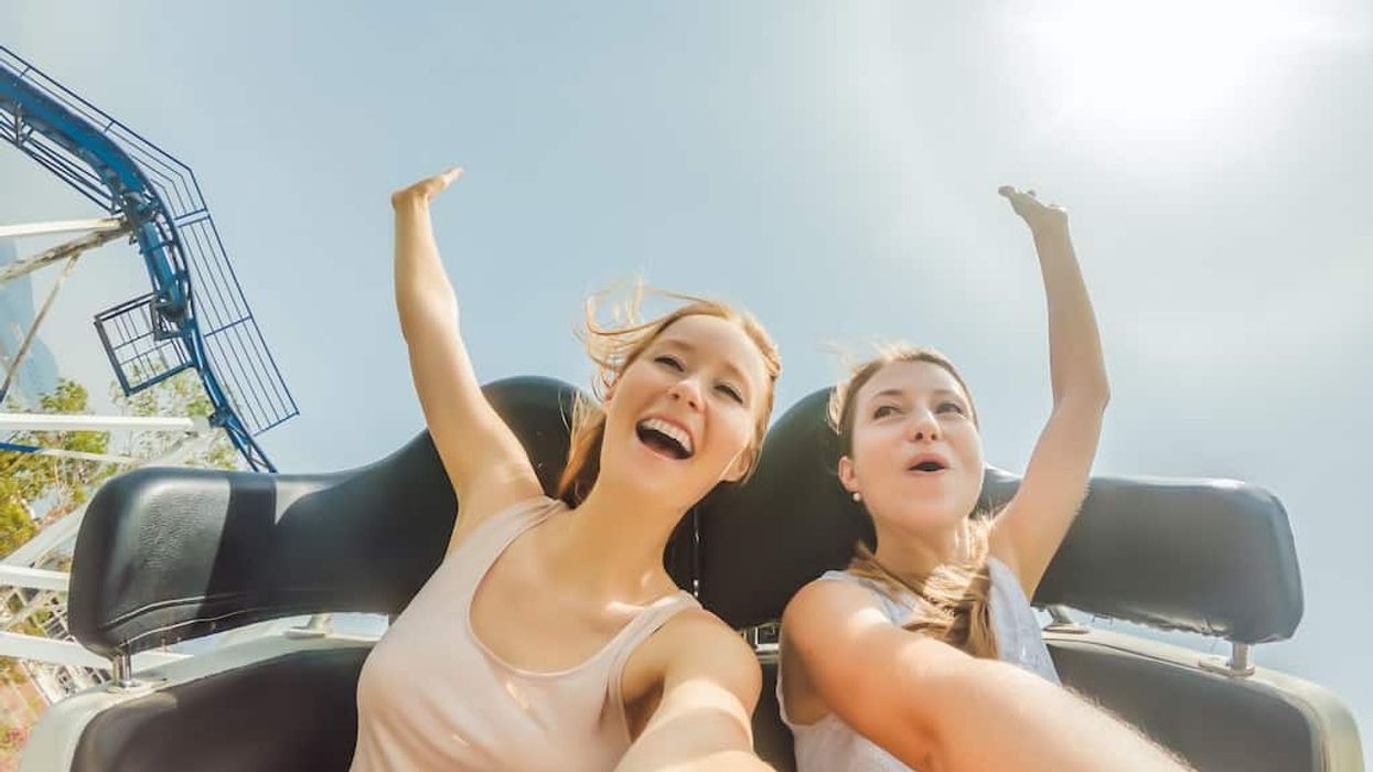 Two happy girls having fun on rollercoaster