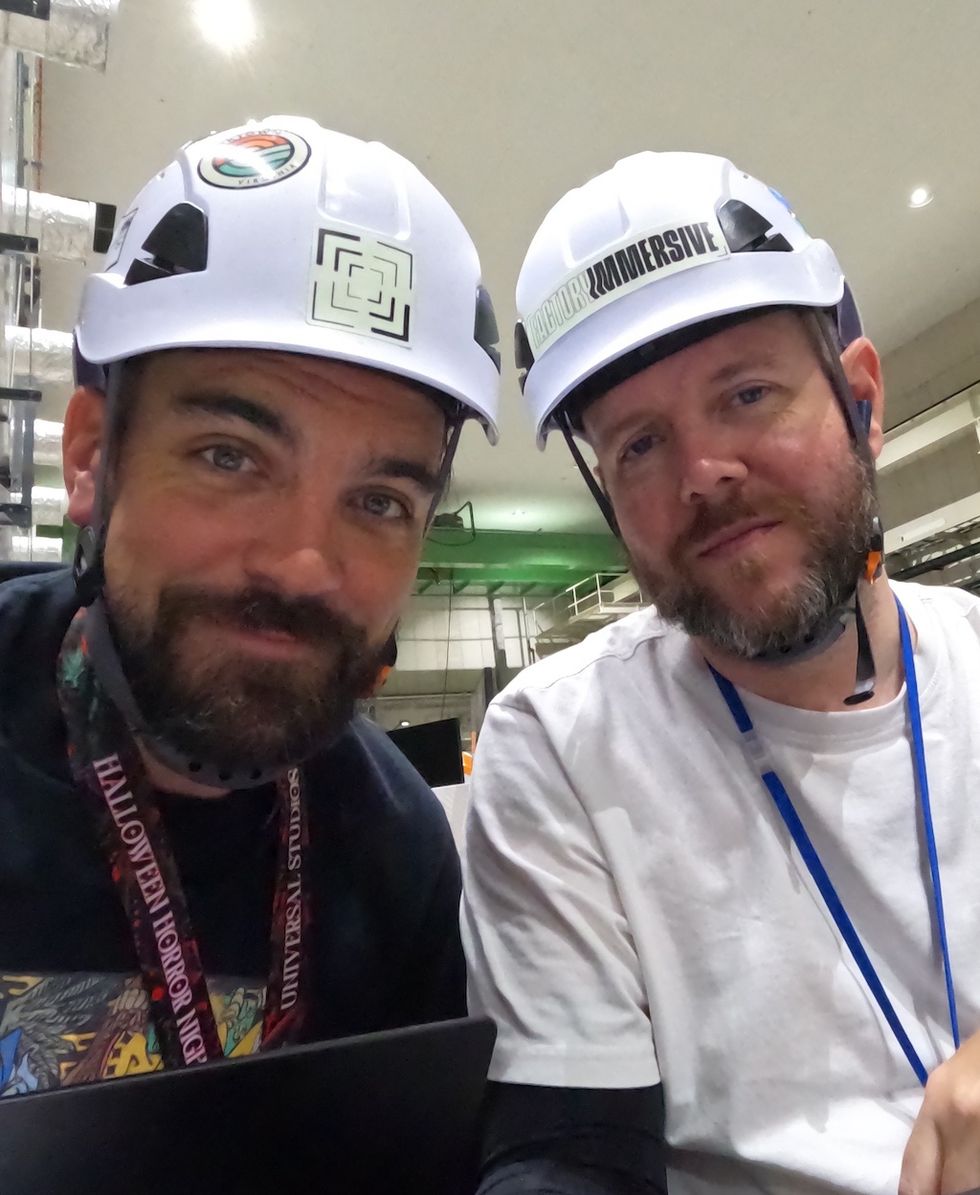Two men, Mike Hill and Steve Lane, wearing hard hats and lanyards, smiling in an industrial setting.