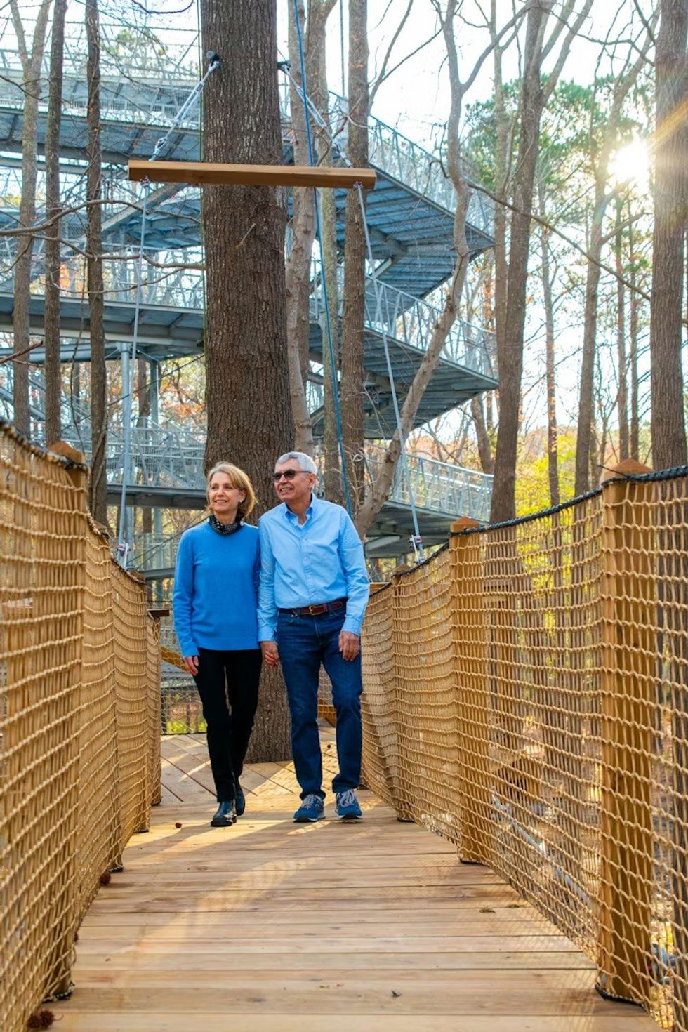 two older people walk across bridge on The Nautilus Observation Tower