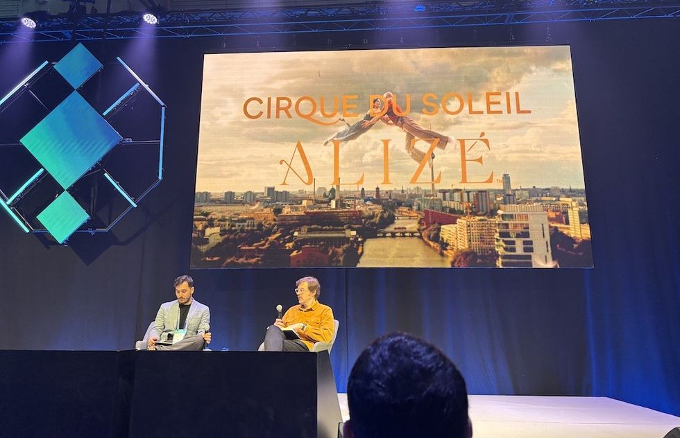 Two people on stage at ISE 2026 with "Cirque du Soleil Aliz\u00e9" displayed on a large screen above.