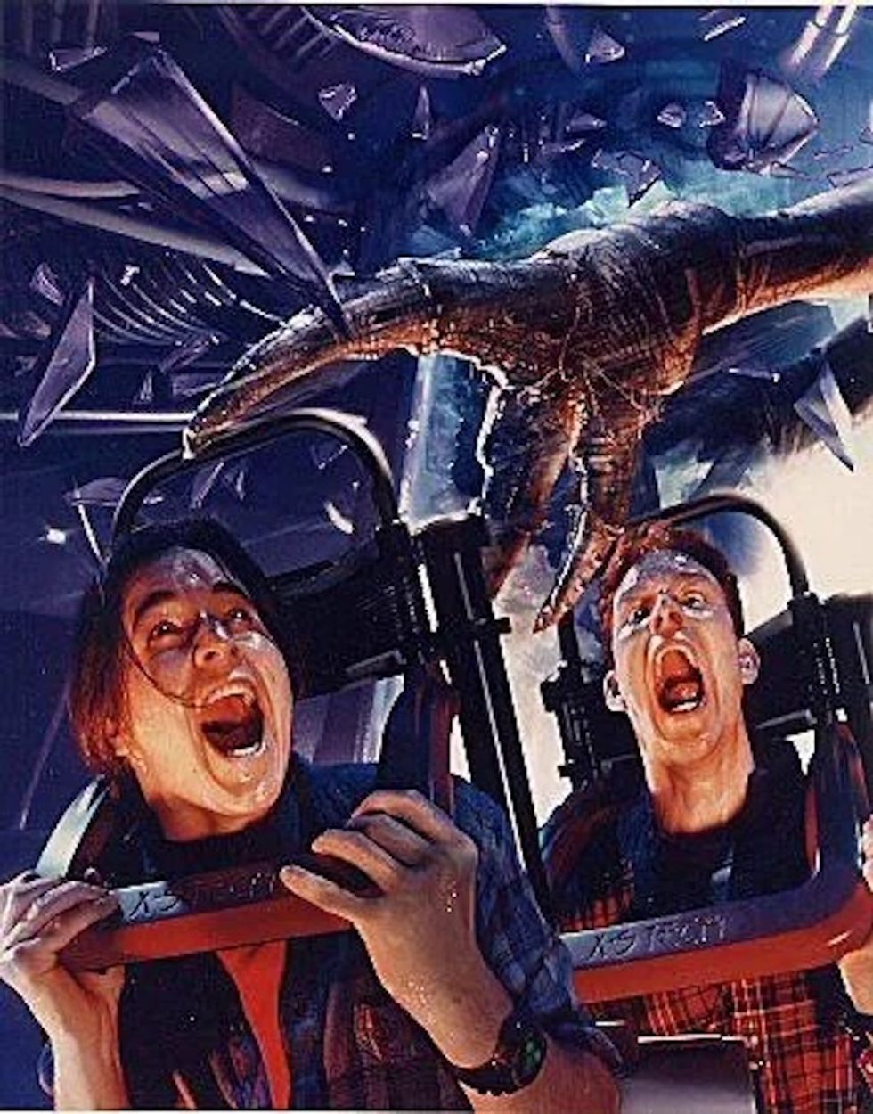 Two people screaming on a Extra TERRORestrial Alien Encounter ride
