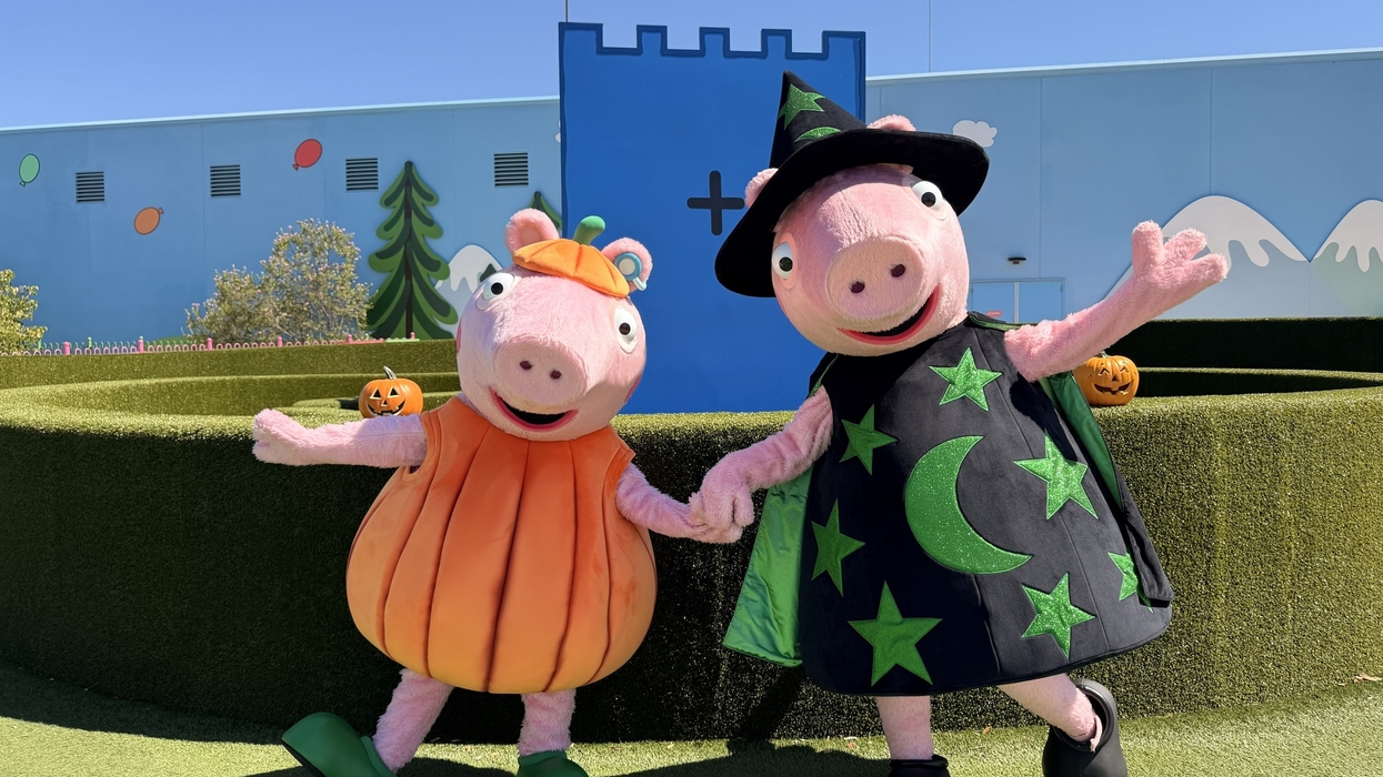 Two Peppa Pig characters in Halloween costumes outdoors.