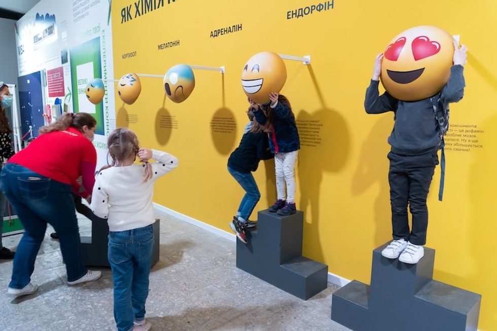 Ukraine Science museum children playing emojis