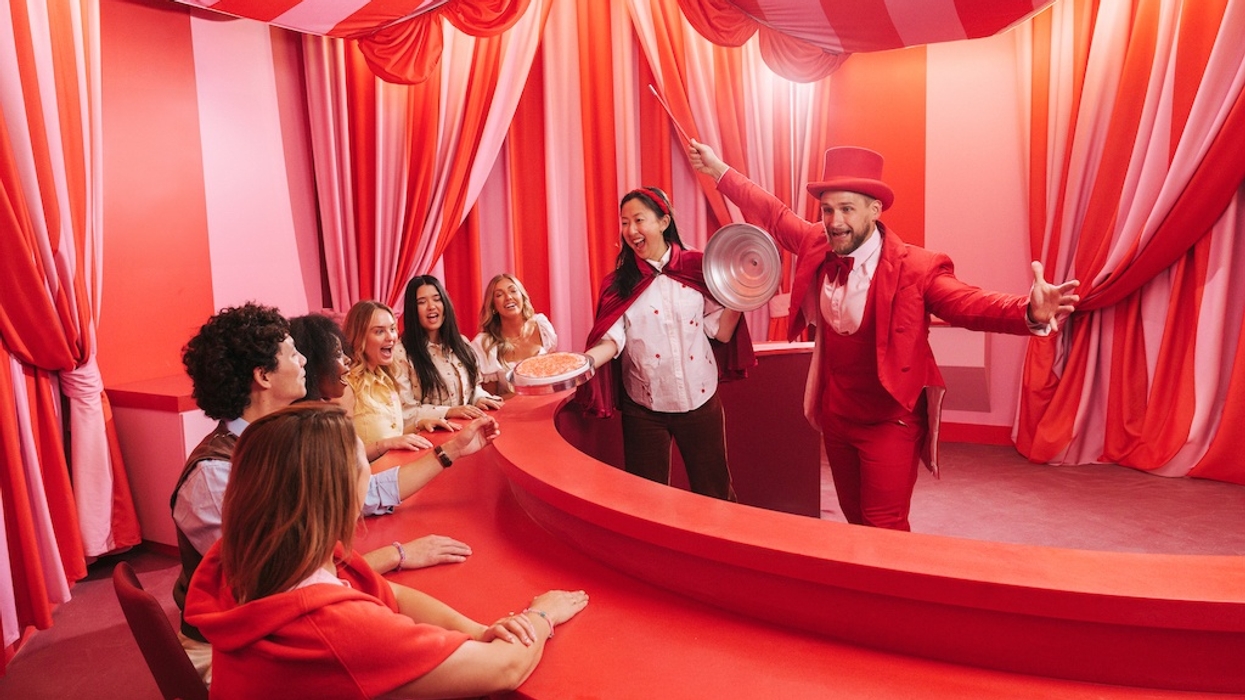 Vibrant circus-themed room with performers entertaining a seated audience, Museum of Ice Cream