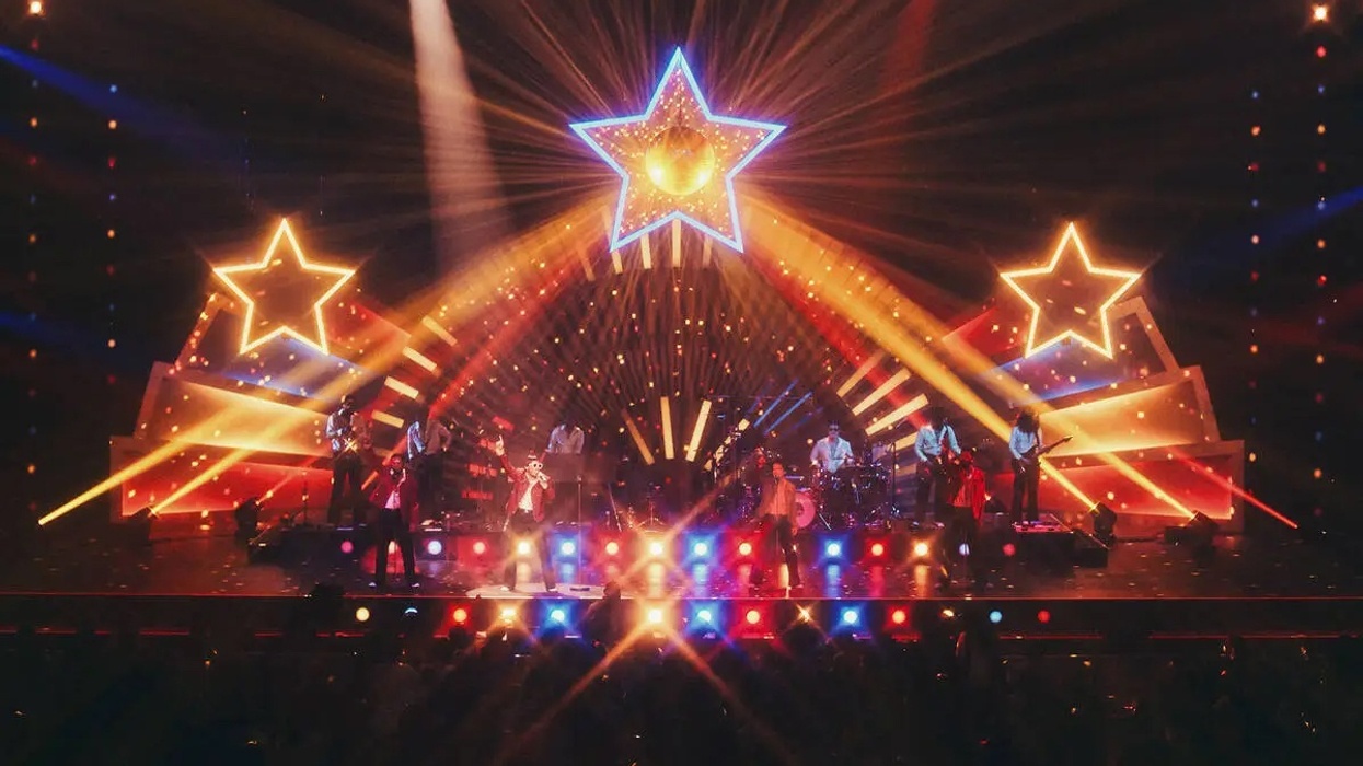 Vibrant concert stage with star-shaped lights and colorful spotlights.