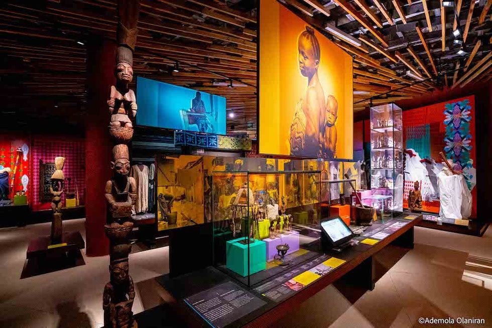 Vibrant museum exhibit with African art, sculptures, and colorful displays
