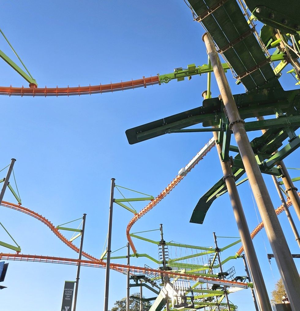 View of a colorful ropes course against a clear blue sky.