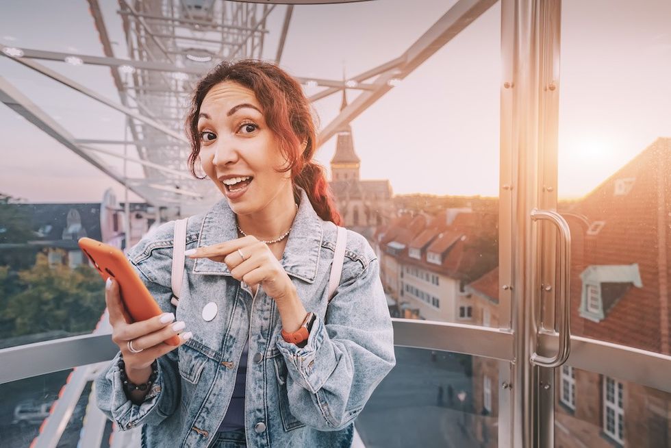 Visitor-using-smartphone-while-riding-observation-wheel