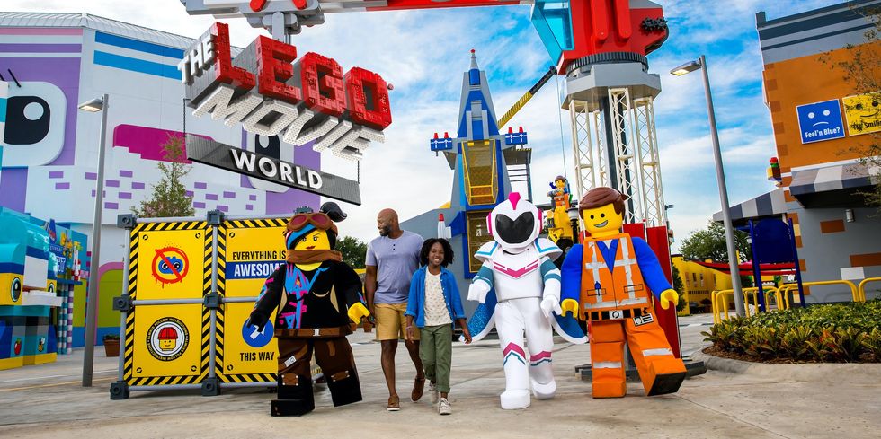 Visitors and Lego characters at The LEGO Movie World theme park entrance.