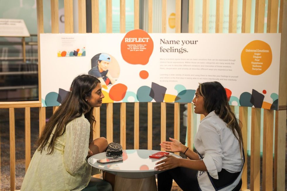 visitors discuss at Uniquely Human Kentucky Science Center