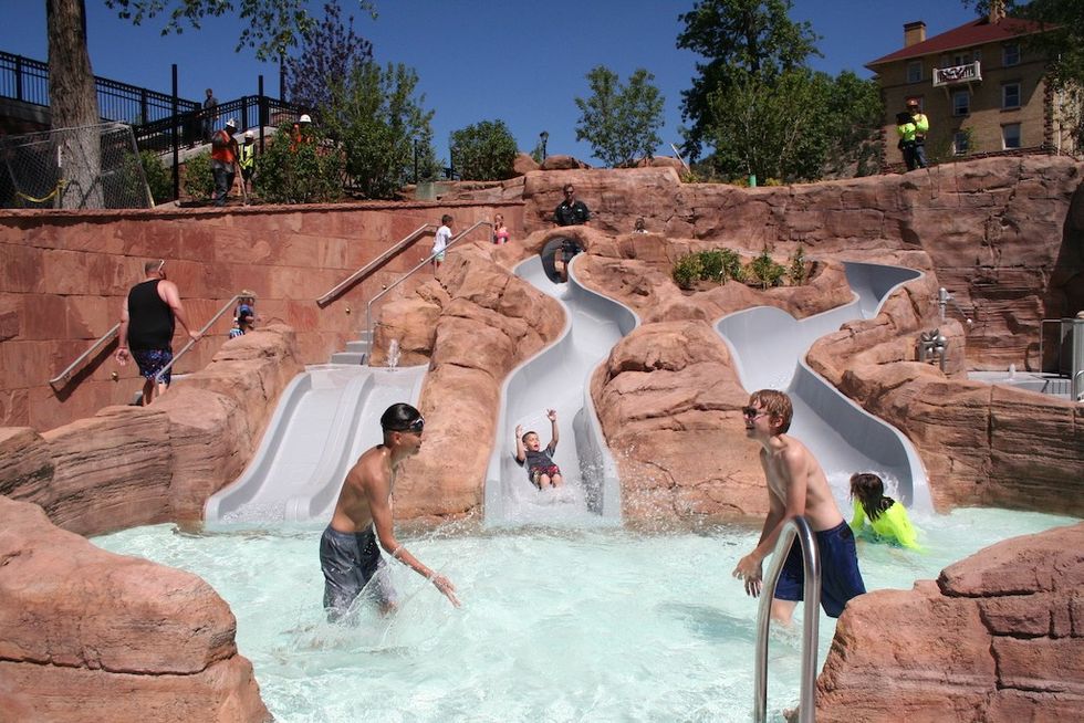 visitors enjoy slides at water park