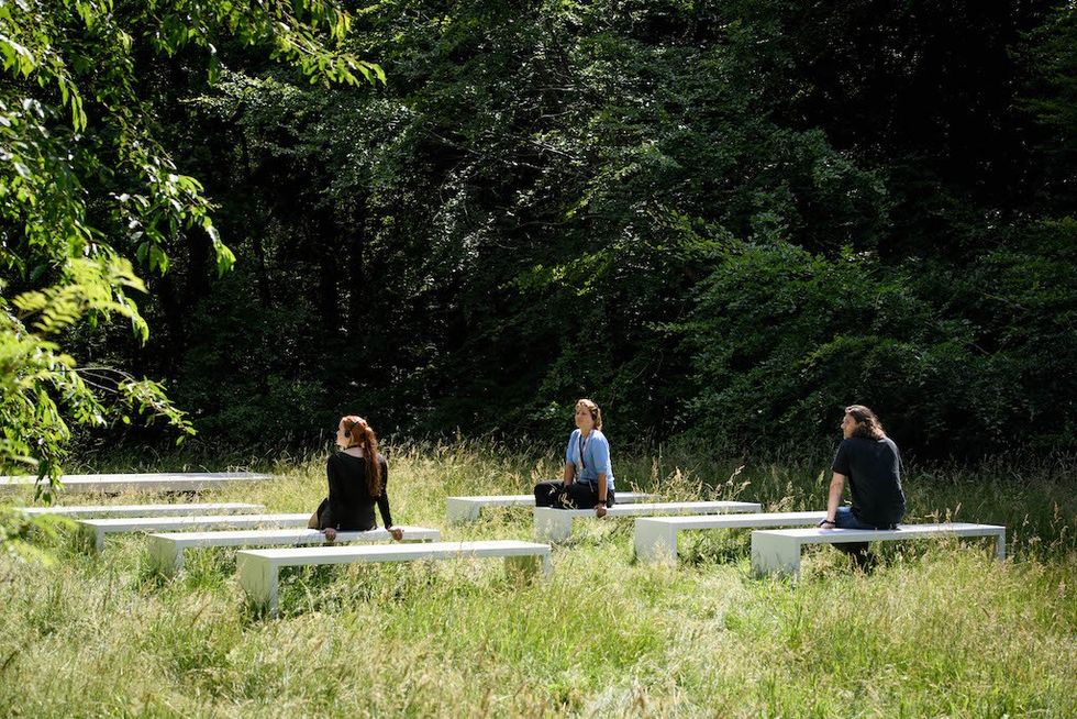 visitors listing to audio outside the refugee museum