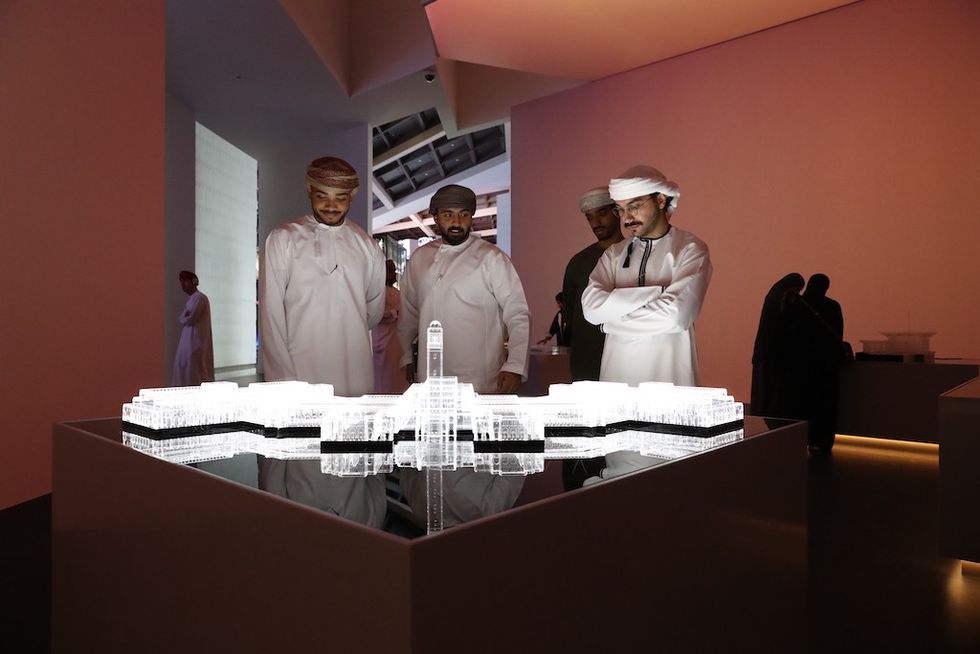 visitors look at building model