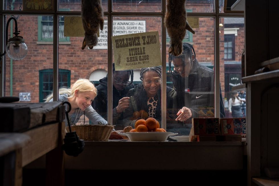 Visitors look through window at Black Country Living Museum