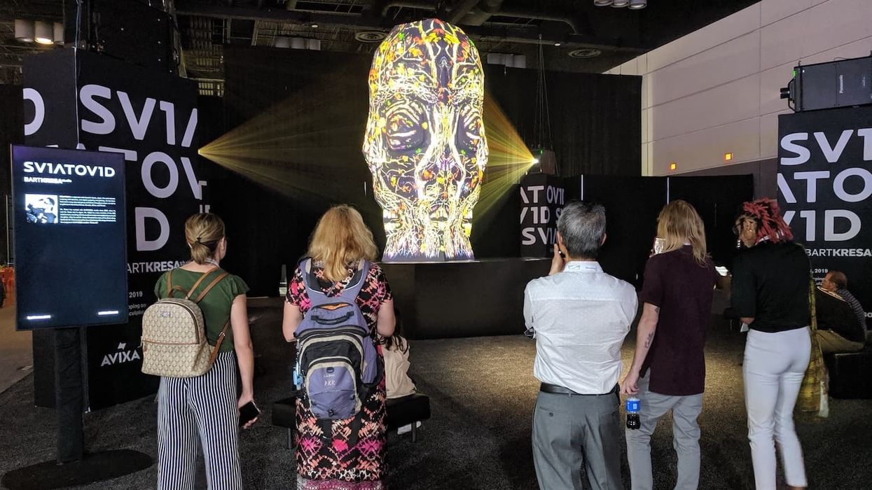 visitors watch Bart Kresa's Sviatovid projection mapping sculpture at infocomm 2019 copy