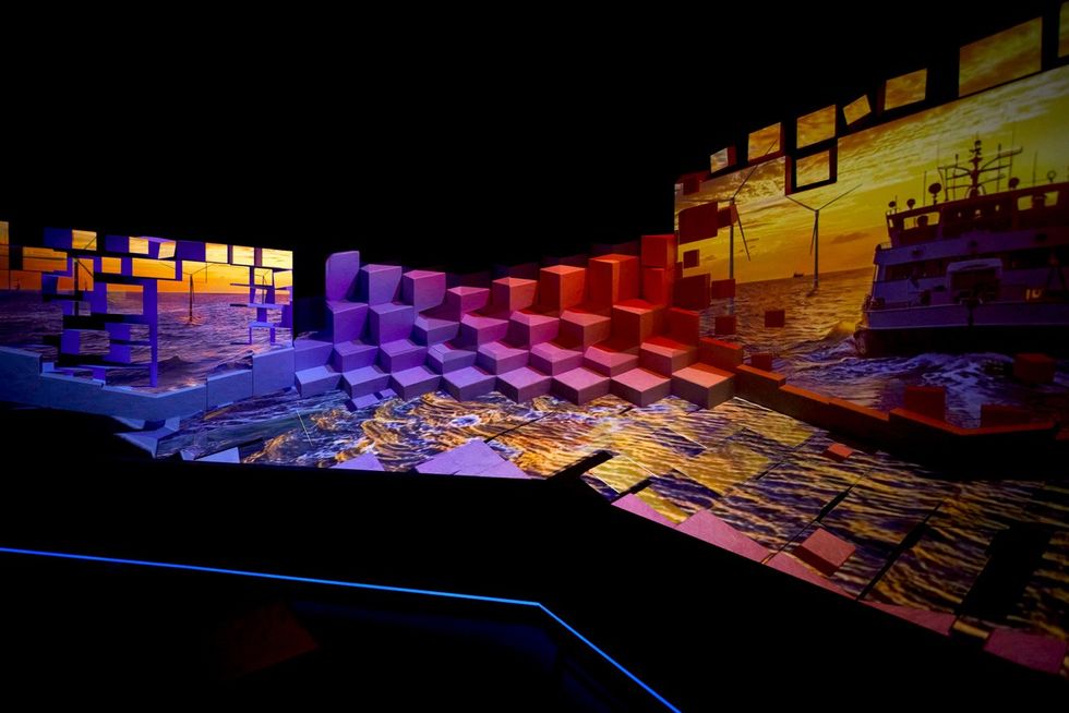 Vivid 3D digital art installation with sunset, ocean, cubes, and ship.