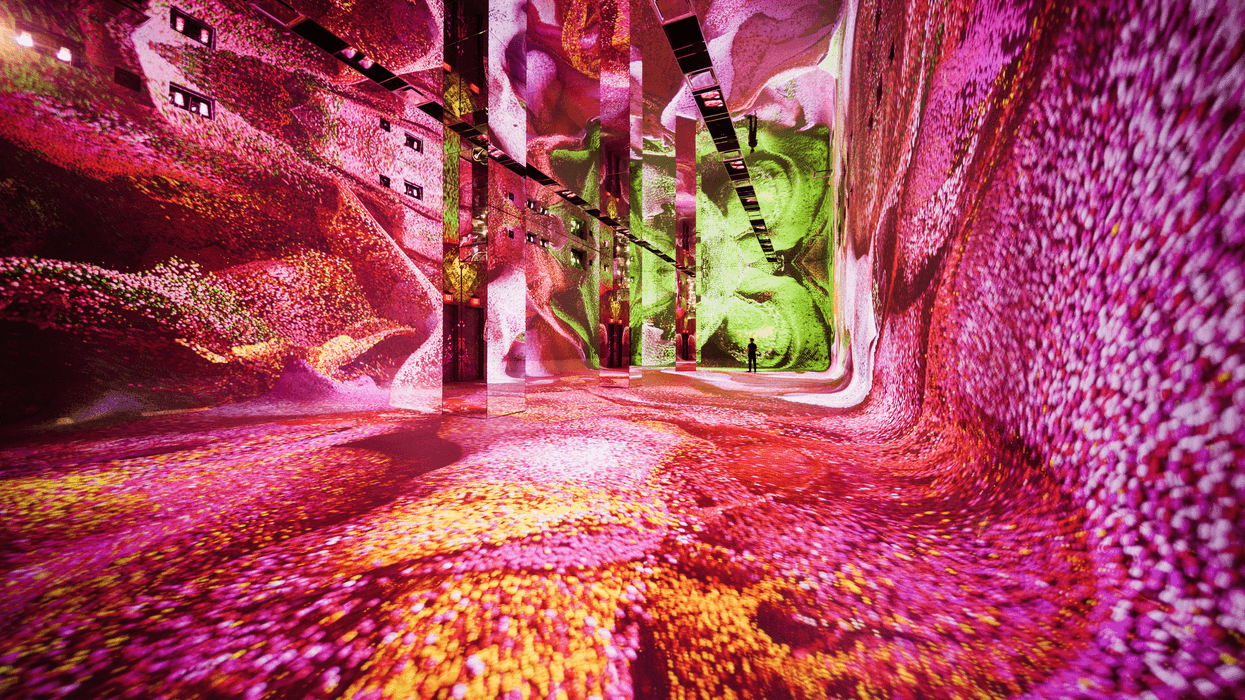 Vivid digital art installation at Dataland with swirling pink and green patterns on walls and floor.