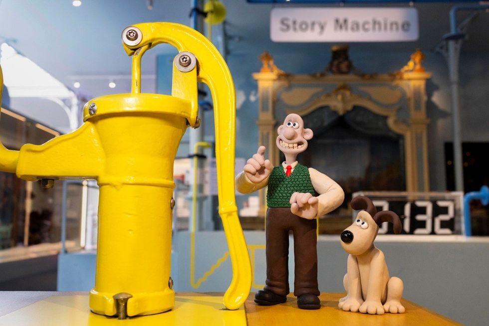 Wallace and Gromit beside a yellow pump, with "Story Machine" in the background.
