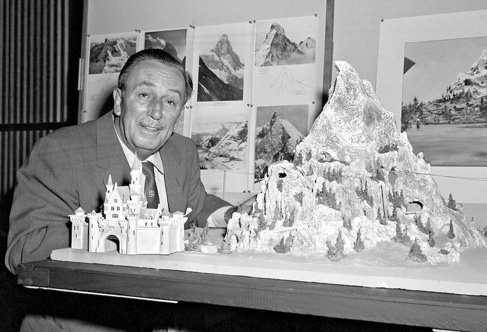 Walt Disney reviews a model for the Matterhorn Bobsleds which opened in 1959 at a height of 147 feet.