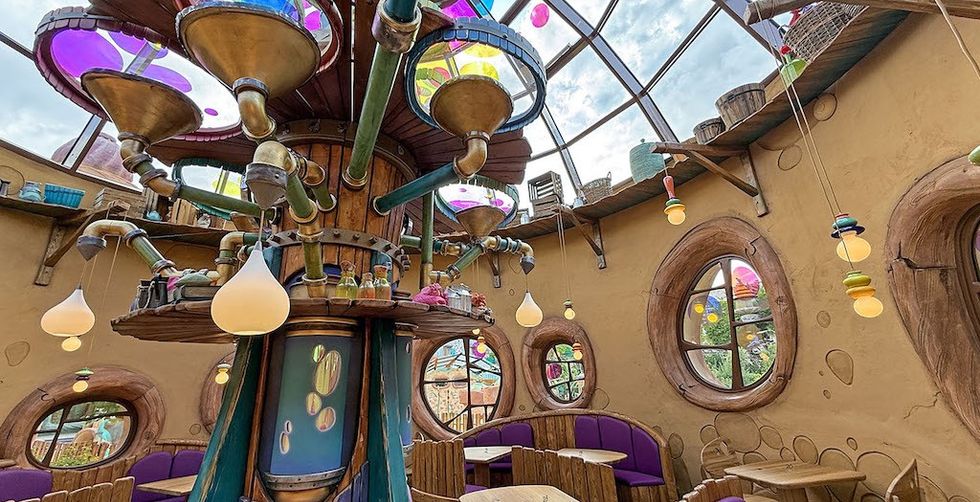 Whimsical interior with colorful, vibrant decor and circular windows.