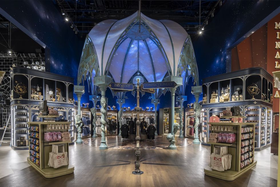 Whimsical retail store interior with ornate displays and celestial ceiling decoration.