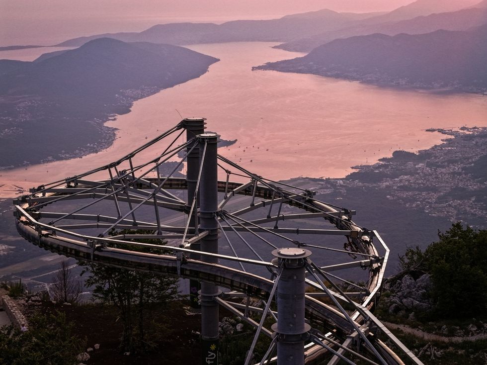 Wie-Flyer track on mountain overlooking bay at sunset.