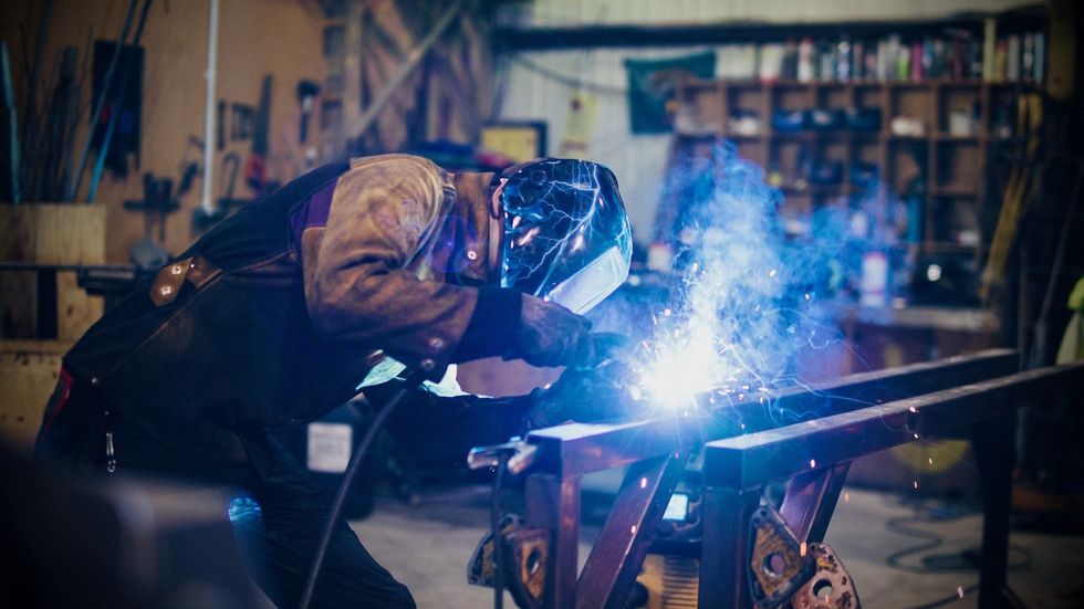 Wild Creations team member welding
