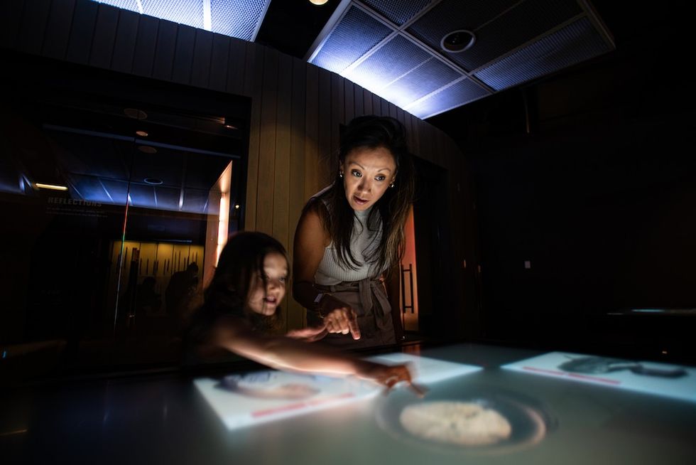 Woman and child interacting with a touch display at National WWI Museum and Memorial