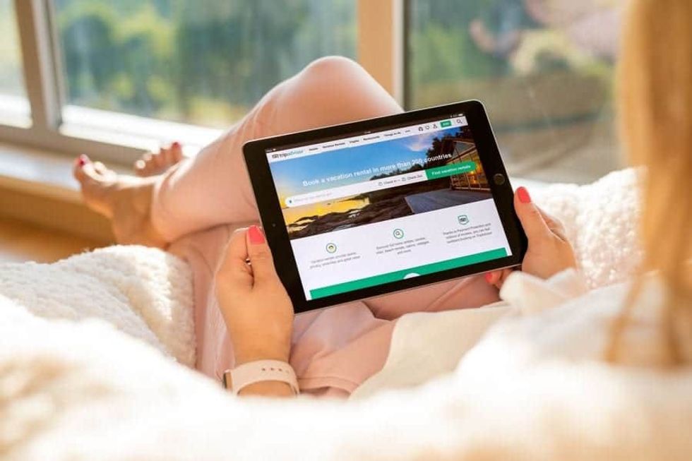 Woman browsing TripAdvisor on her iPad