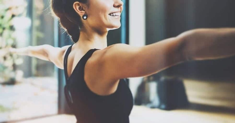 Woman exercising with her arms extended to her sides 10 travel trends