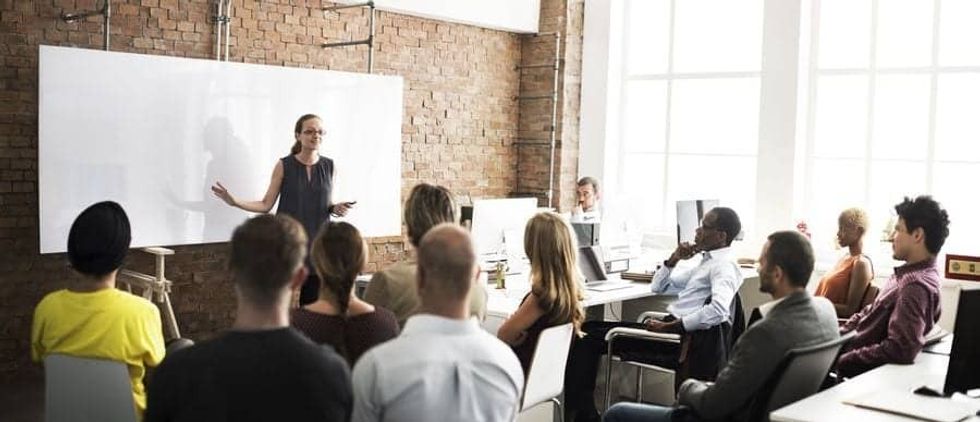 Woman giving training to a class of people