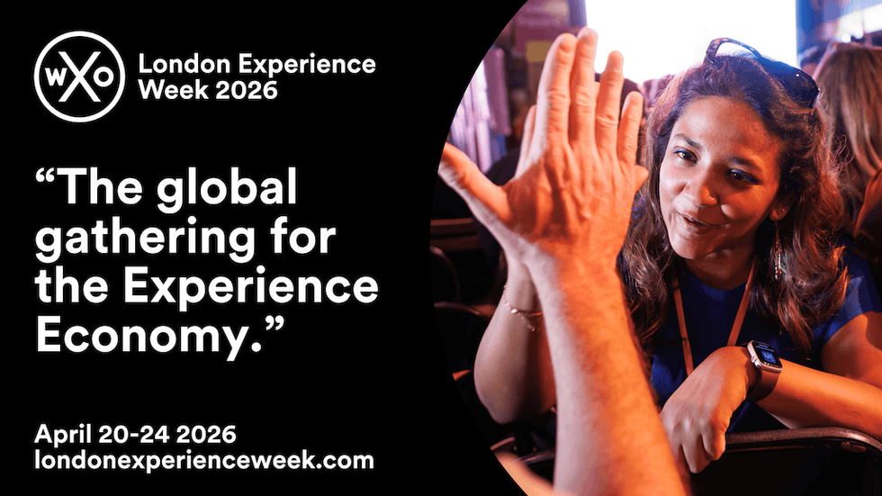 Woman high-fives at London Experience Week 2026 event, "The Experience Economy."
