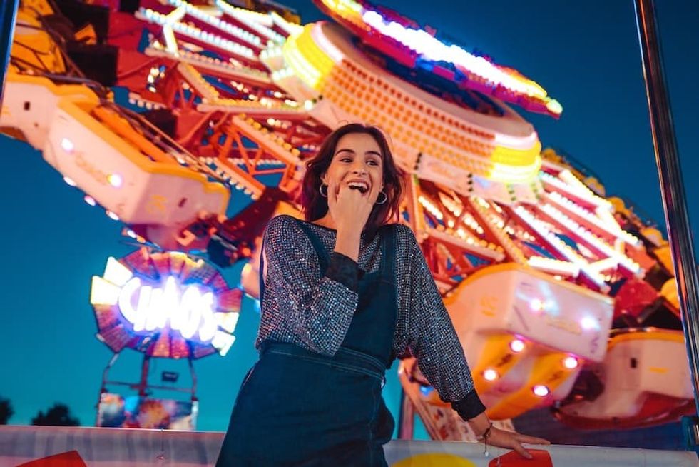 Woman in front of ferris wheel