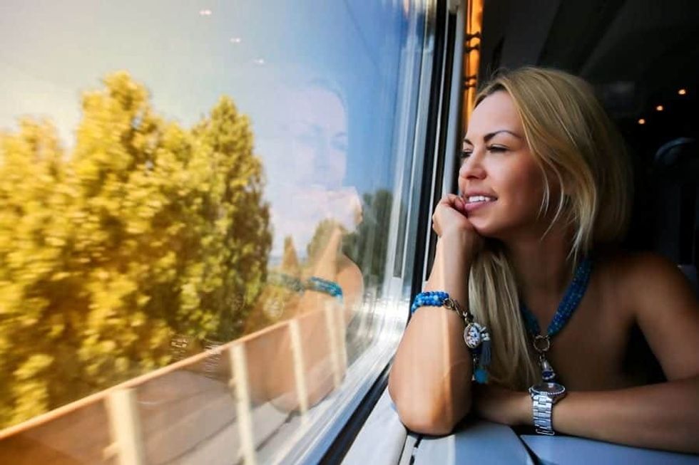 Woman looking at the passing scenery on a moving train