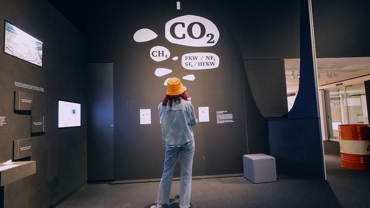 woman-looks-at-museum-exhibit-on-climate-change