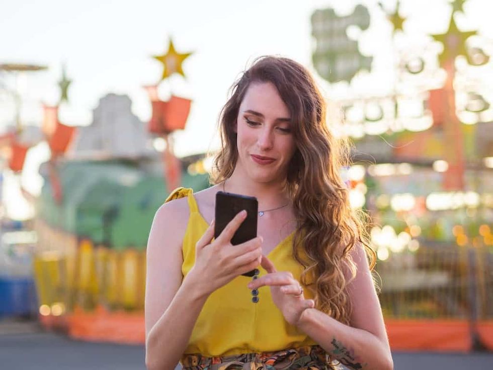 Woman-on-mobile-phone-in-theme-park
