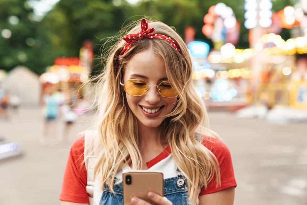 woman-on-phone-in-theme-park theme park reservations