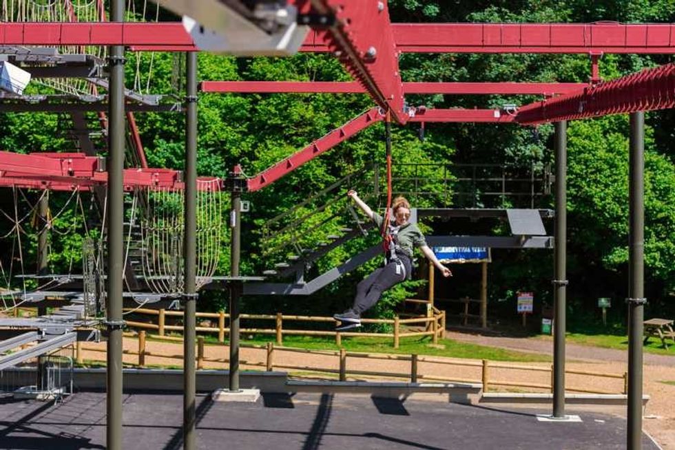 woman on predator high ropes course at roarr! dinosaur attraction