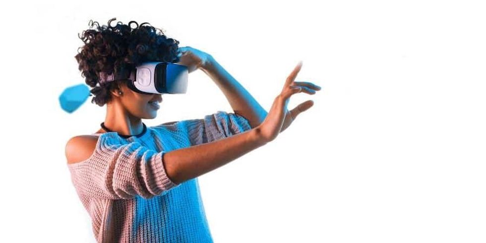 woman wearing virtual reality VR goggles - what AV tech will we use after covid-19?