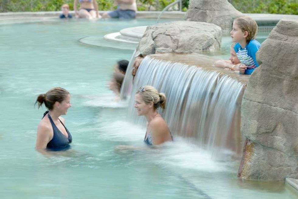 women and kids by waterfall in ouray hot springs pool
