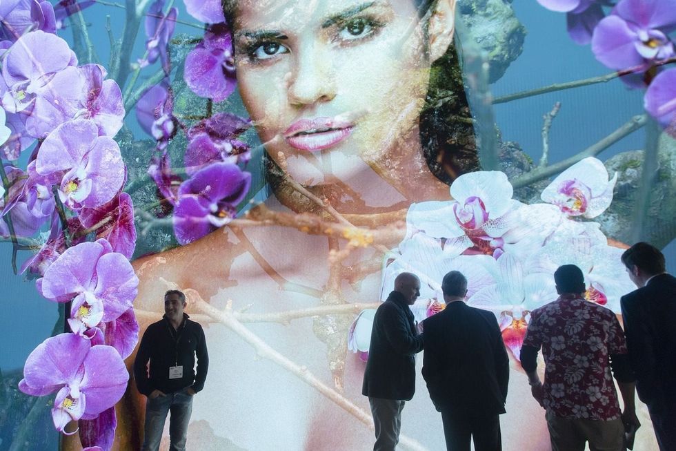 womens face on large screen audiovisual display at ise