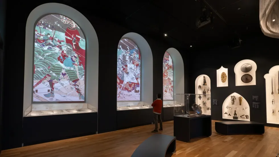 Worcester Art museum interior with ornate arch windows and artifact displays on walls.