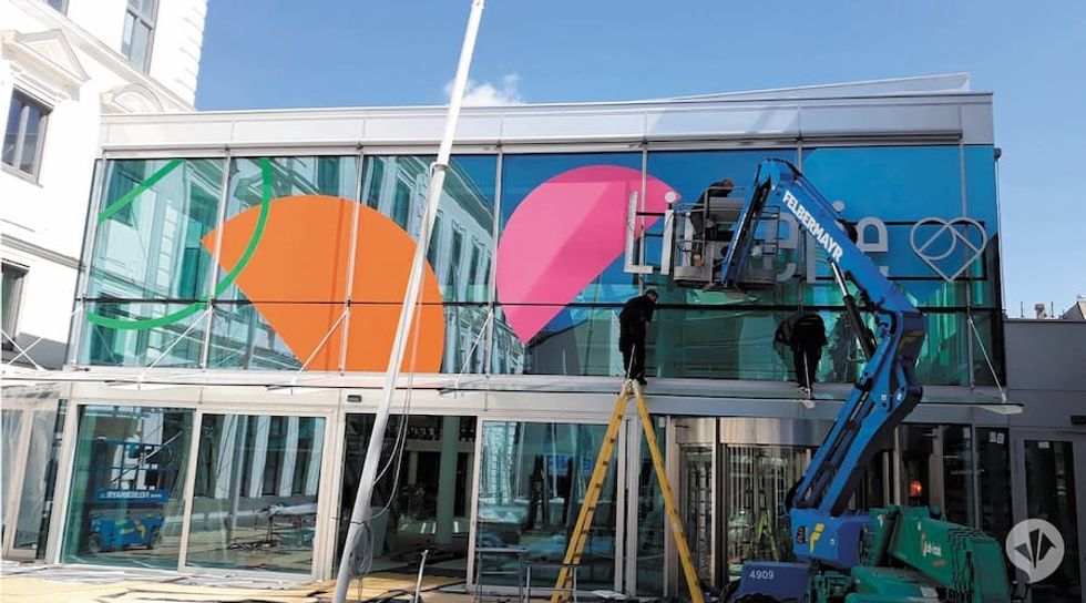 Workers put up new sign on Austrian shopping mall Linzerie