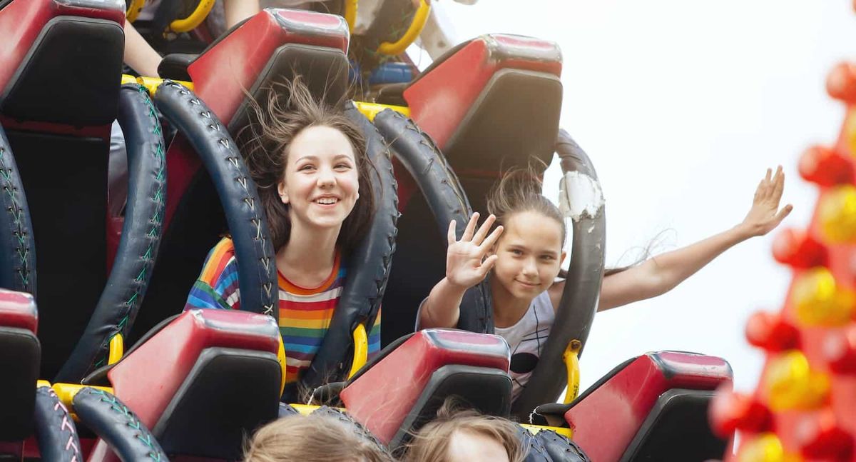 Young friends on roller coaster ride.