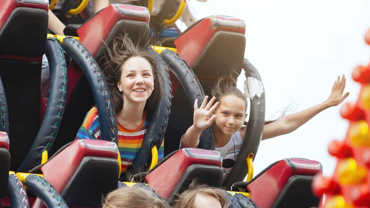 Young friends on roller coaster ride.