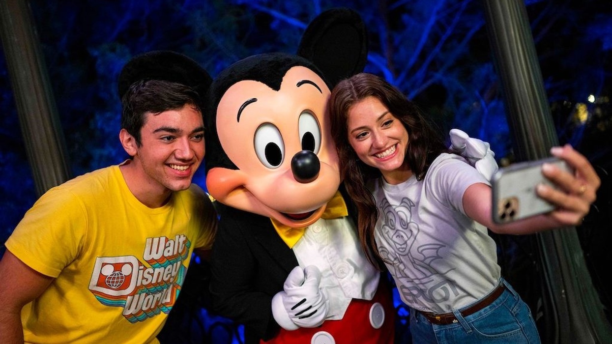 Young-people-pose-at-Disney-with-Mickey-Mouse