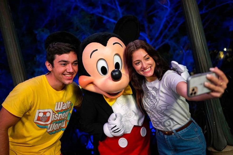 Young-people-pose-at-Disney-with-Mickey-Mouse