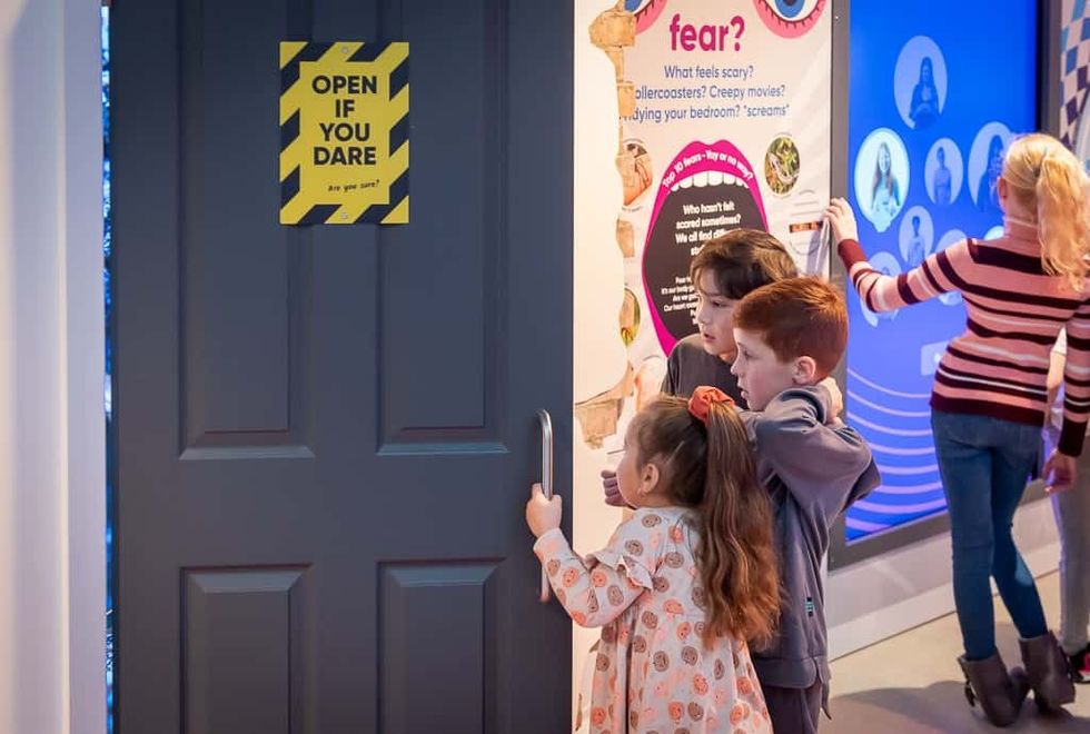 young visitors open a door at the new Science + Discovery museum on the Wirral