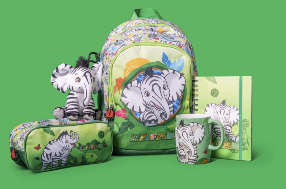 Zafari-themed backpack, notebook, mug, pencil case, and plush toy on green background.