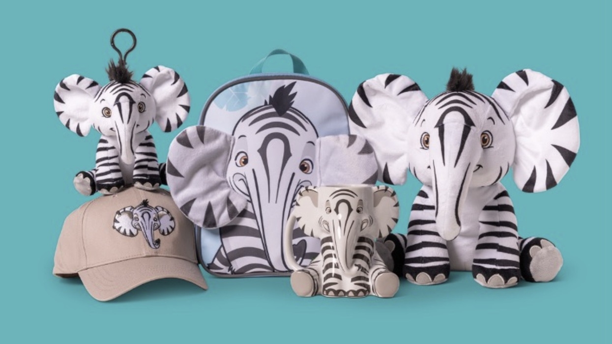 Zebra-elephant plushies, mug, cap, and backpack on a teal background.